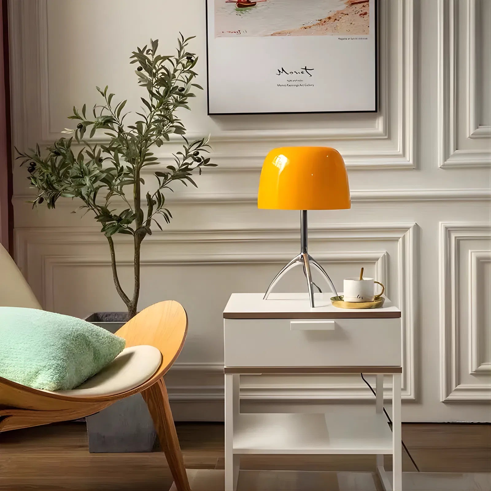 Bellaro Tri-Leg Retro Table Lamp in orange styled on a console table beside a green armchair in a classic interior