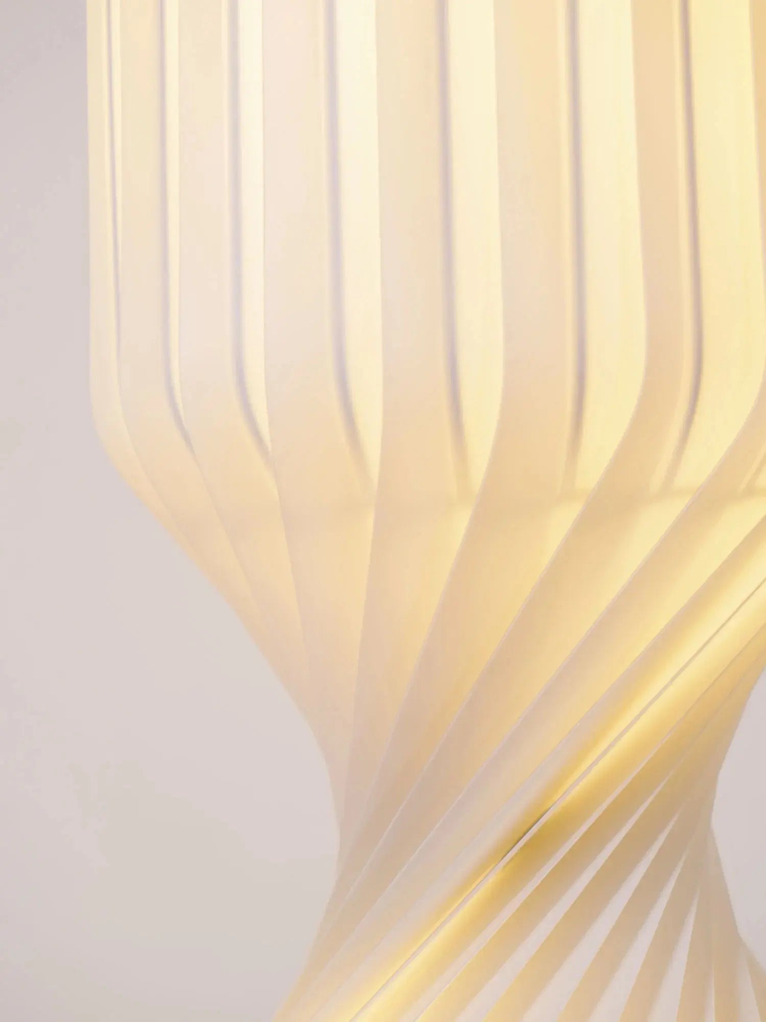 Solenne ribbed floor lamp warm glow close up light through white resin column